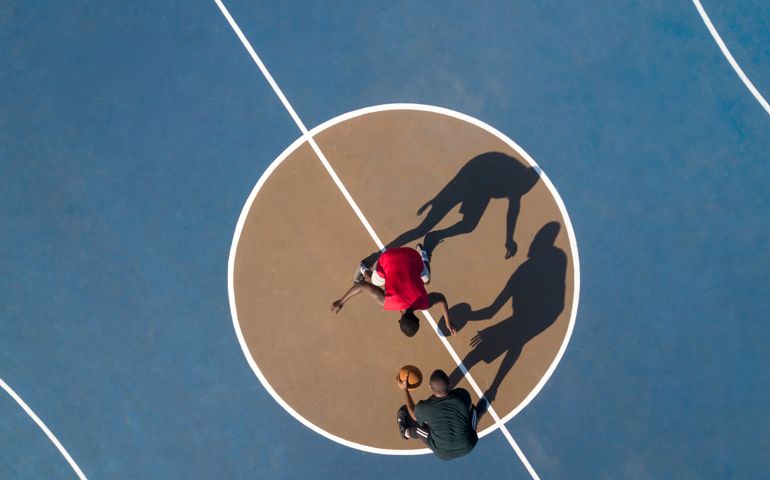 Aerial shot of 2 basketball players and shadows