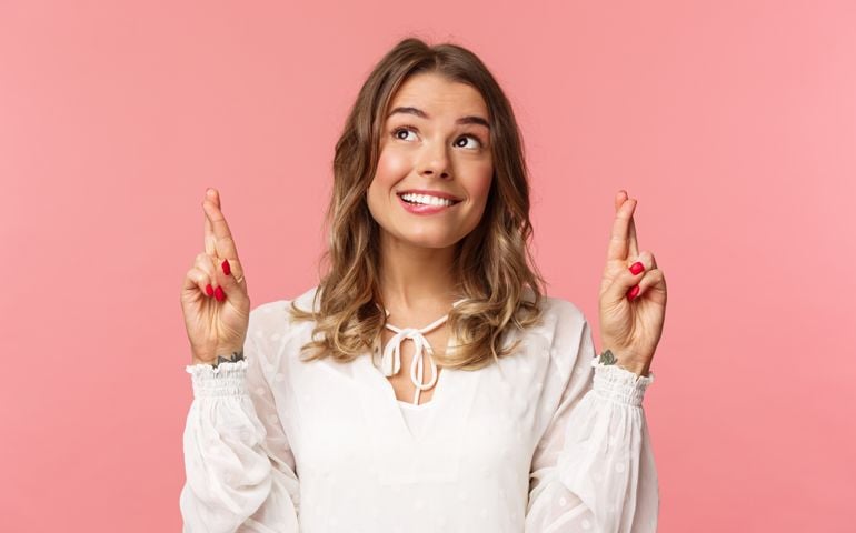 Close-up portrait of hopeful, optimistic attractive woman in white dress,
