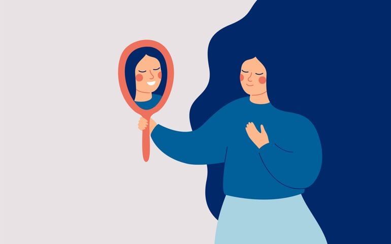 Young woman looks at the mirror and sees her happy reflection