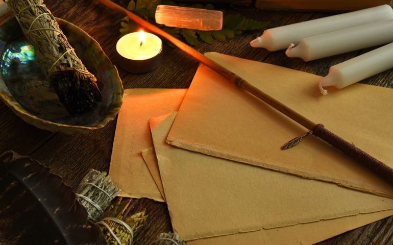 Blank paper, magic wand, and magic candles