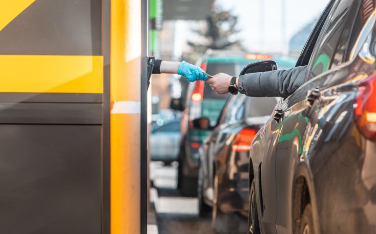 paying for fast food from the car at drive-through close up