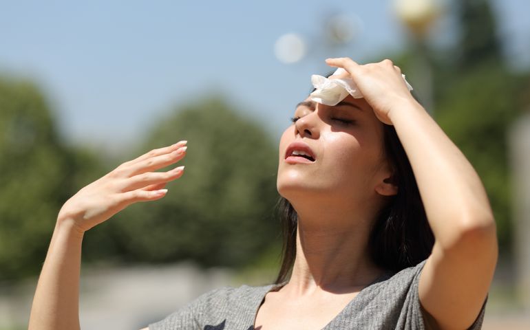 woman drying sweat in a warm summer day