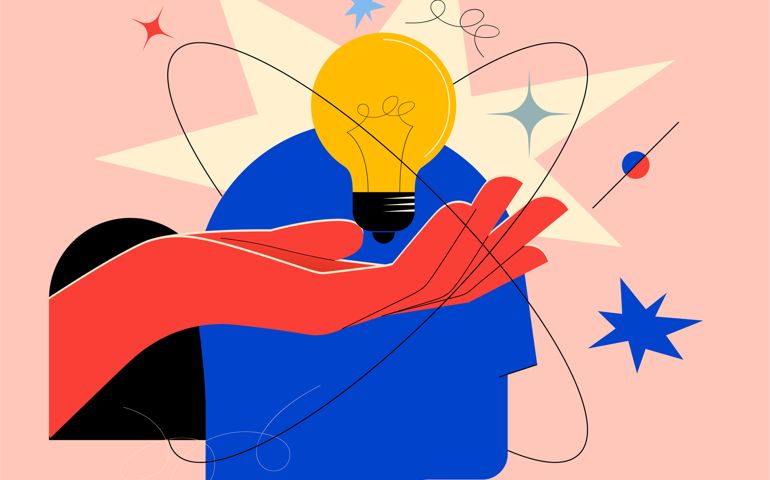 Creative mind or brainstorm or creative idea concept with abstract human head silhouette and hand holding bulb lamp