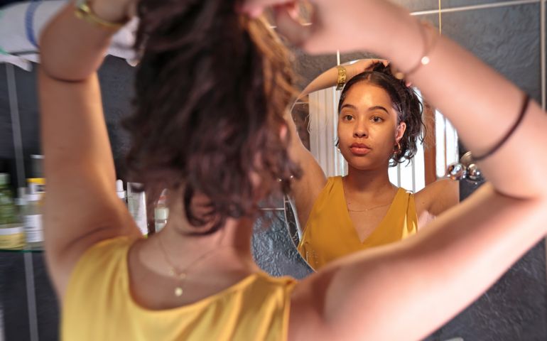 woman tying hair up
