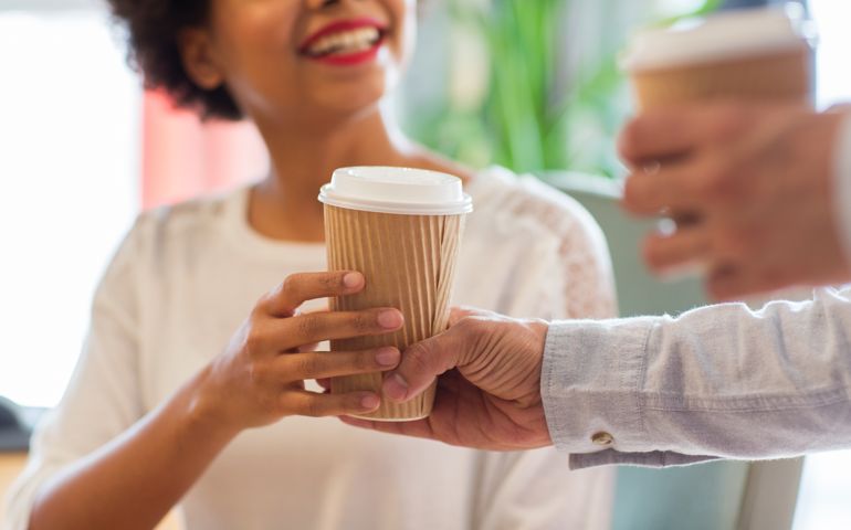 close up of happy woman hand taking coffee cup