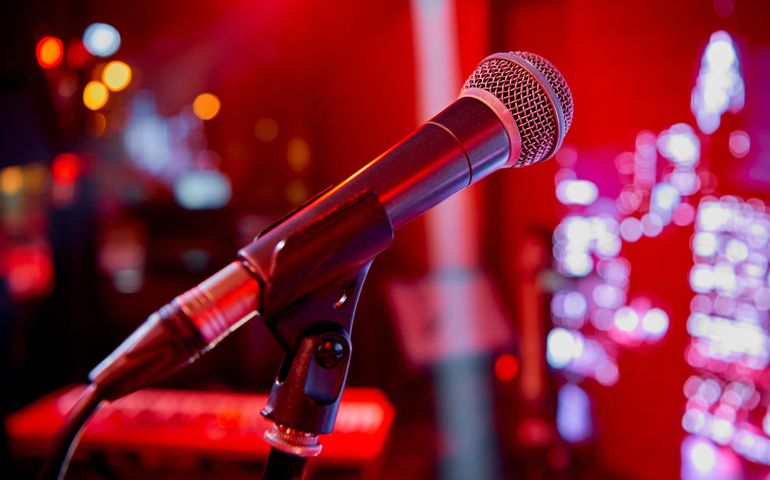 Microphone on the stage in the bar of the cafe restaurant with red colorful lighting. High quality photo
