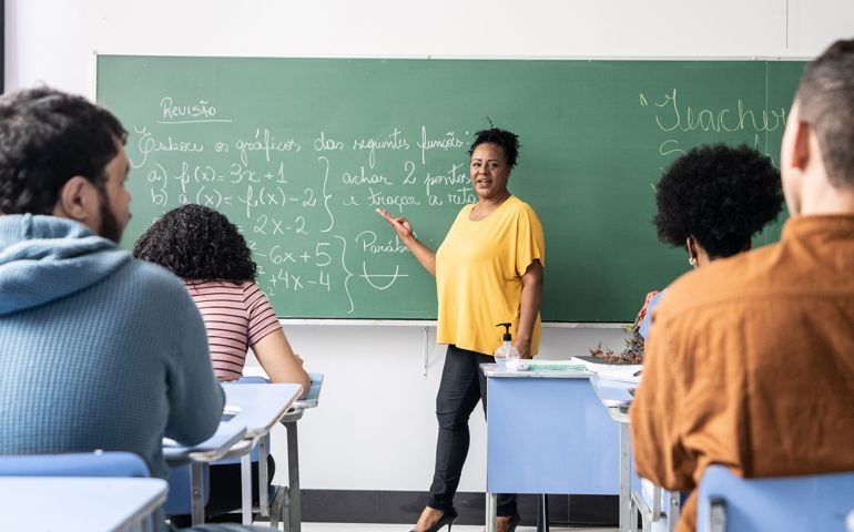 Teacher talking students during class at school