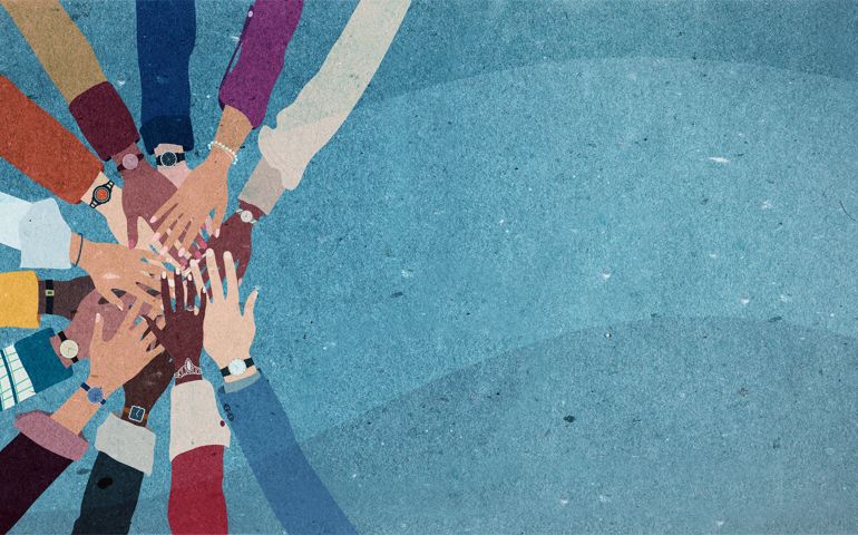 Group of arms and hands in a circle of diverse people.