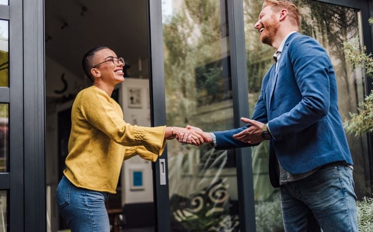 Shaking hands handshake greeting good old friend, client, job professional or new employee, two persons welcoming each other