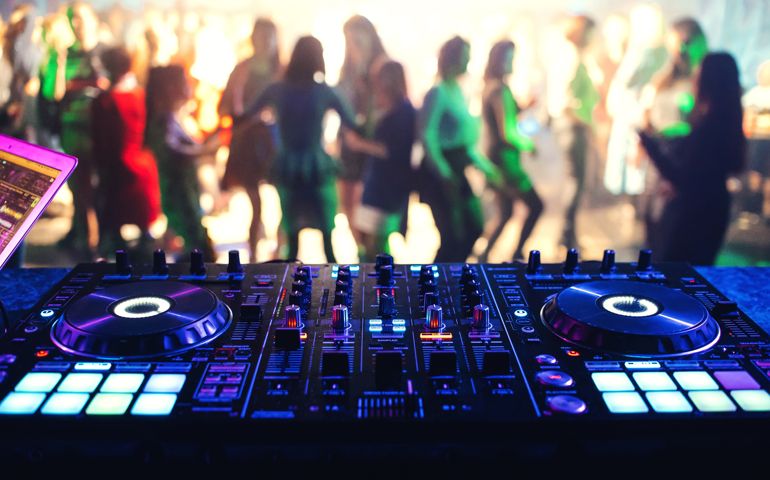 music controller DJ mixer in a night club at a live electronic music concert