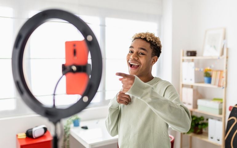 Young male creator recording online media video on his room