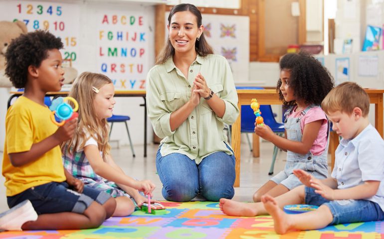 Shot of a teacher singing with her preschool children