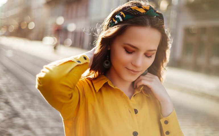 woman looking downwards with headband