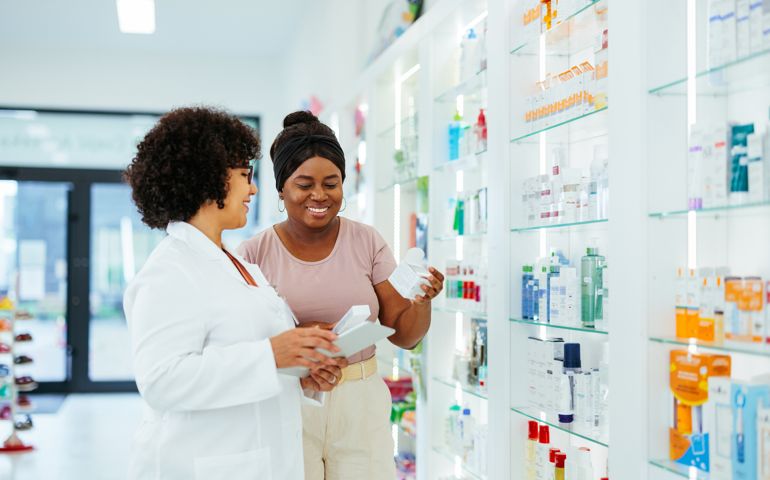 A customer is buying medical skin care products in a pharmacy