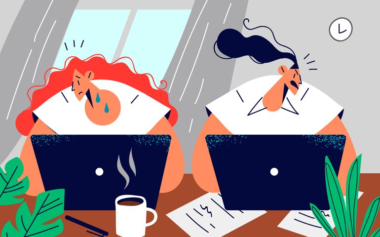 Unfriendly female employee at desk with upset colleague.