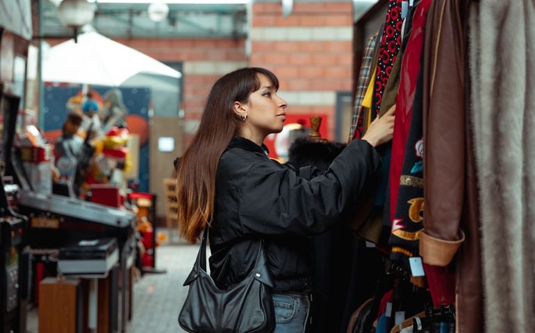Young woman shopping vintage clothing