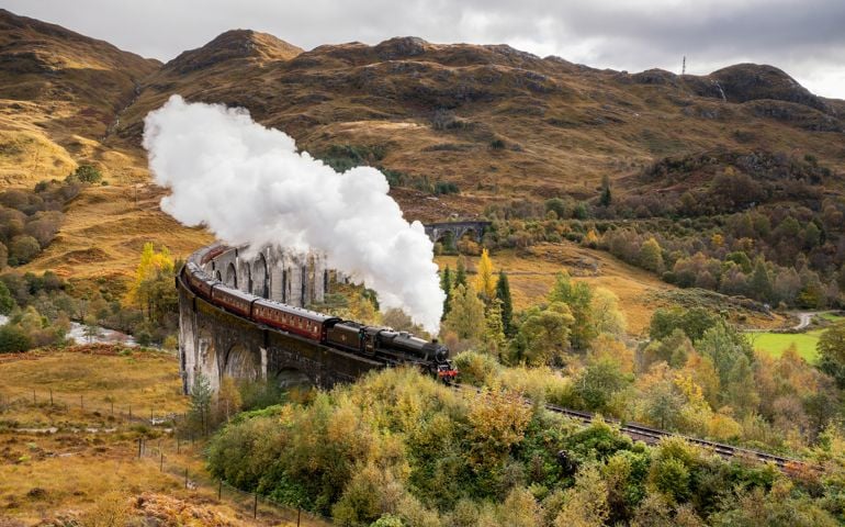 The Jacobite Steam train Crossing the Glenfinnan Viaduct in Scotland.
