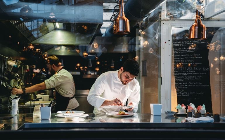 A chef is cooking in his restaurant's kitchen