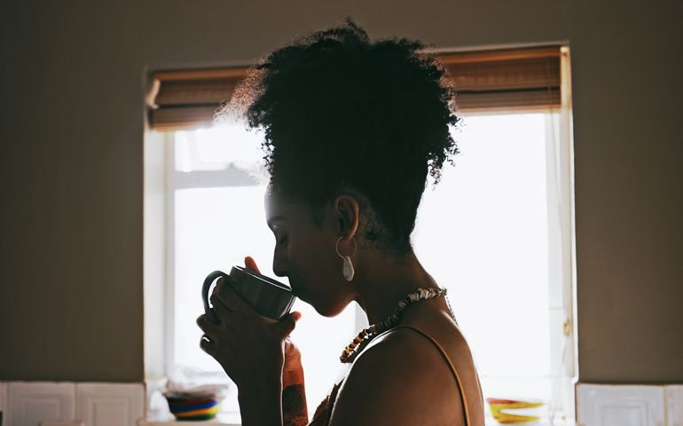 Coffee, woman relax in kitchen for calm, peaceful and happiness in morning. Reflection, happy