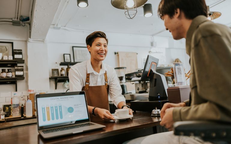 barista serving hot drink to customer