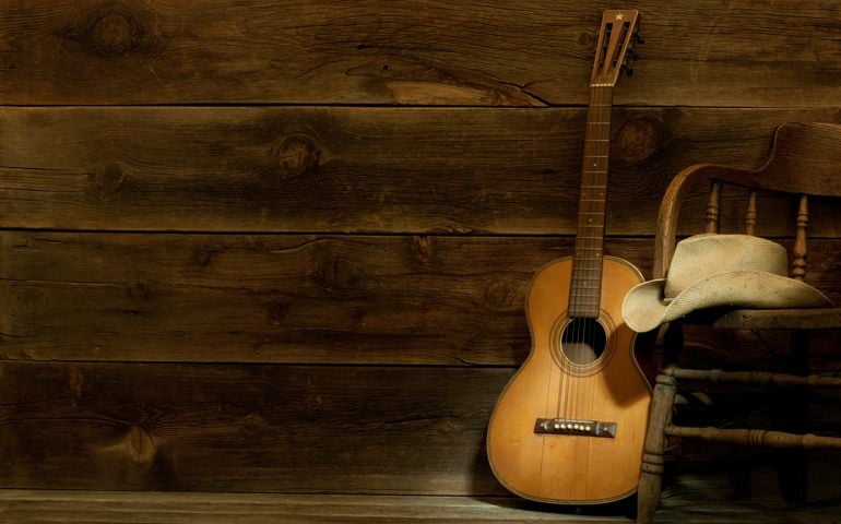 Country and Western Music scene w/chair,hat,guitar-barnwood background