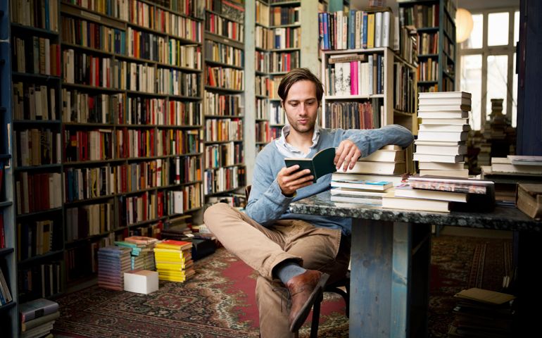 Man reading books in bookstore