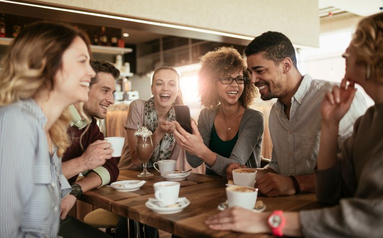 Photo of friends having coffee in cafe