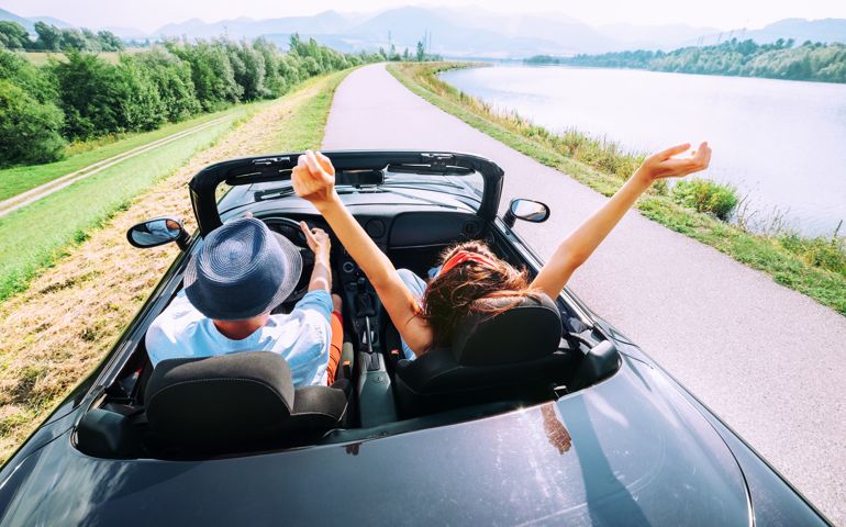 Couple in love ride in cabriolet car