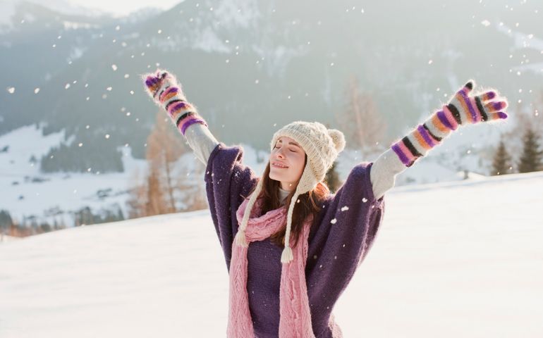 Woman with arms outstretched in snow