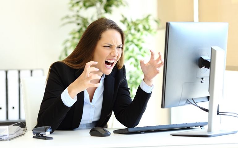 Angry office worker checking computer content