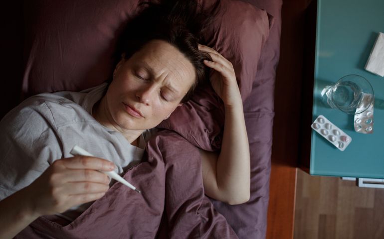Sick woman checking the temperature