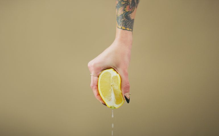 hand squeezing lemon