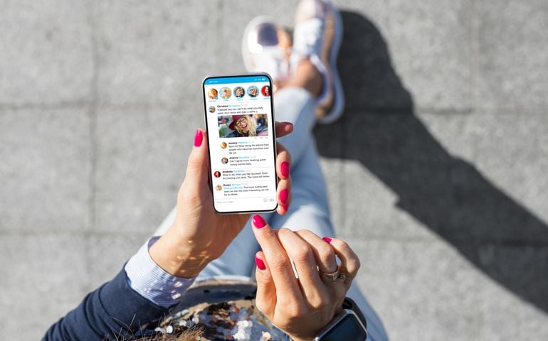 Woman using social media microblogging app on her phone