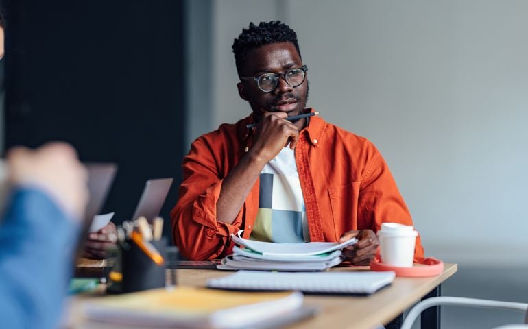 man thinking while in meeting