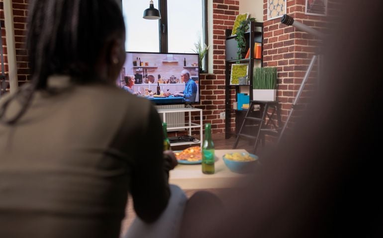 group of friends watching soap opera movie on television