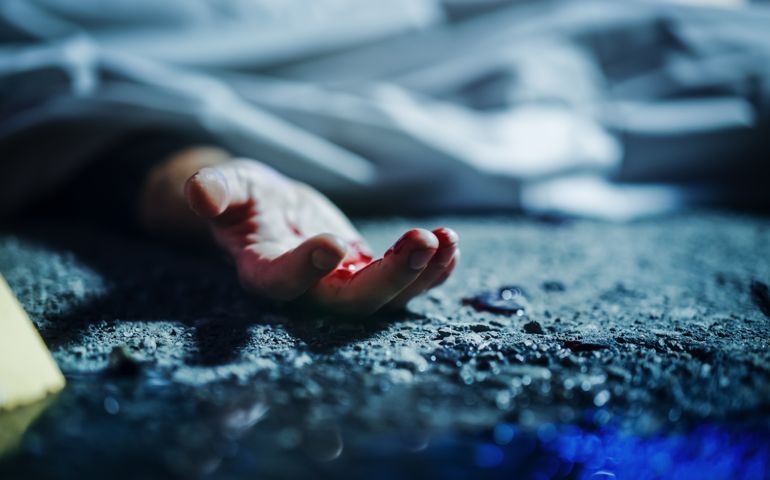 Extreme Close-Up on Victim's Bloody Hand. Still Dead Body Under a Cover and Next to Numbered Markers.