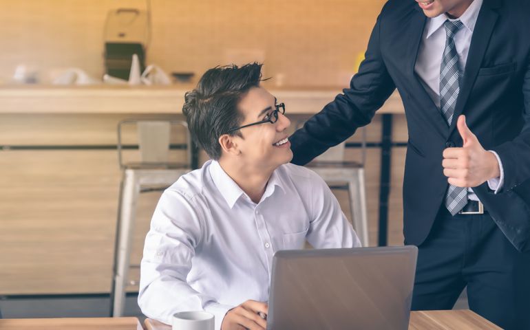 Businessman was given a thumbs-up and compliments from his boss who successfully worked.