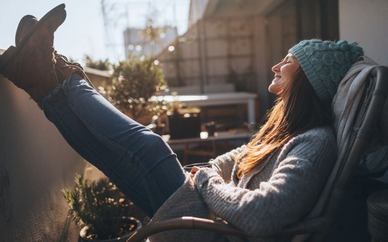 woman with feet up outside with sunshine