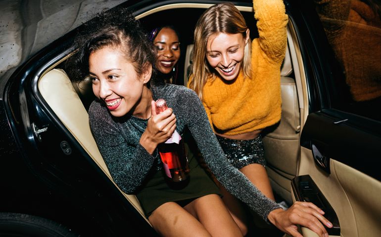 women in a backseat of a cab