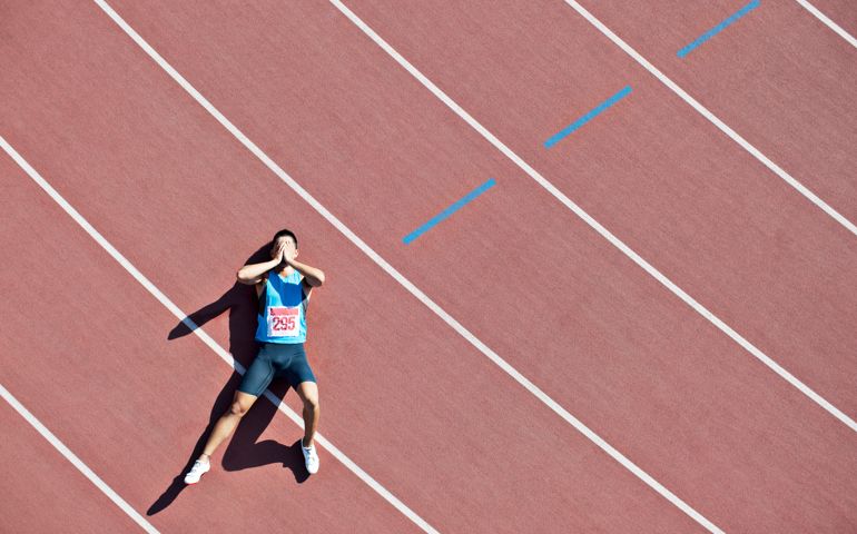 Tired runner laying on track