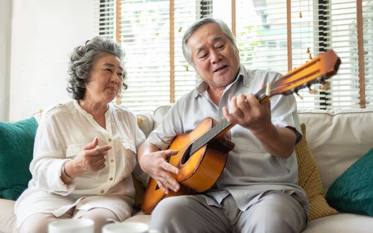 Older Couple enjoying with singing and guitar.