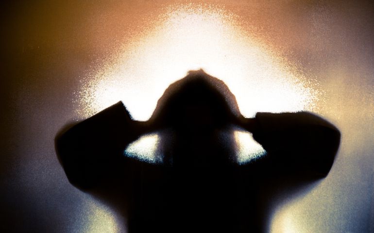 silhouette of a woman holding head
