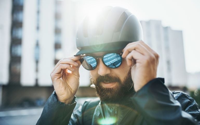 man with helmet putting on glasses