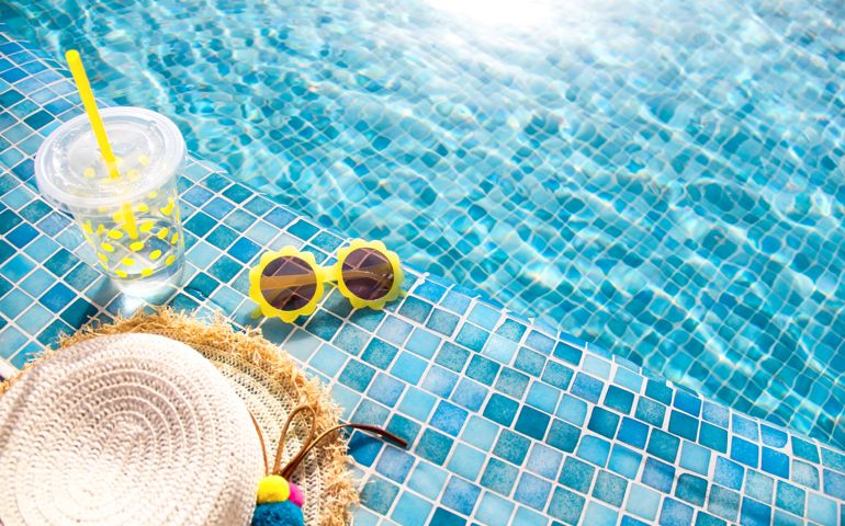 Summer vacation concept. Stylish yellow sunglasses, hat and fresh cocktail.