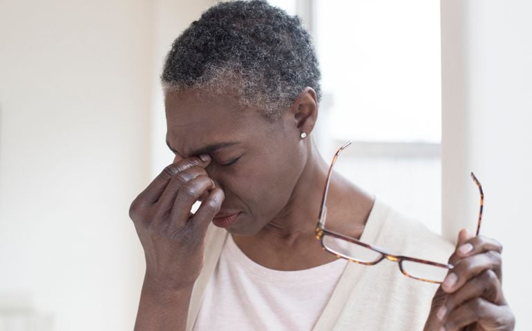 Woman touching bridge of nose
