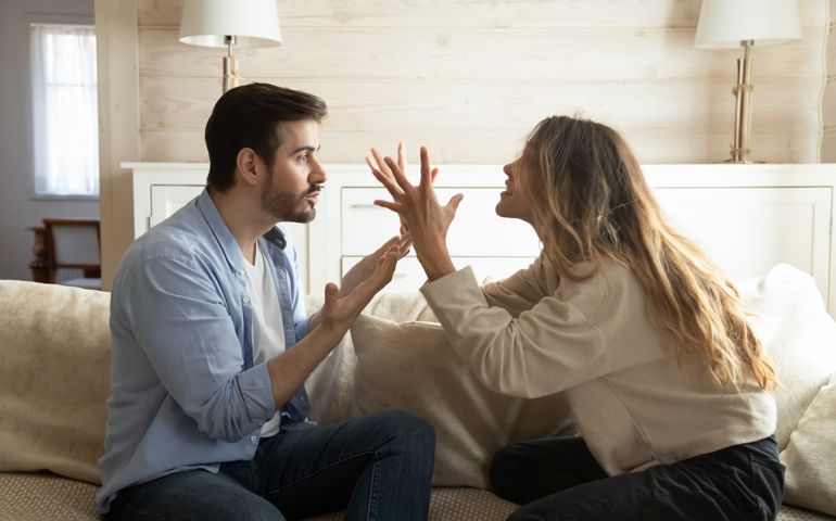 Emotional annoyed stressed couple arguing at home.