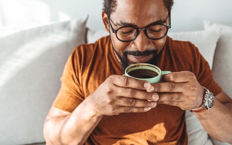 man with sunglasses drinking coffee