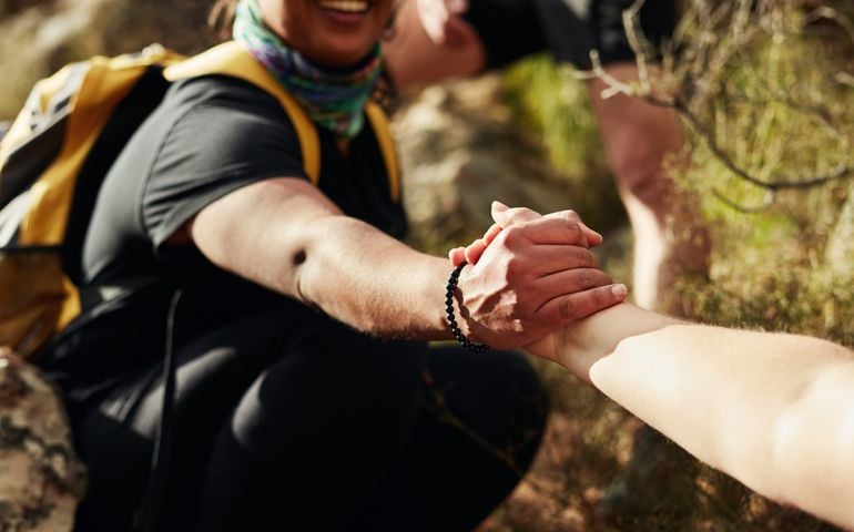 woman holding hand for support