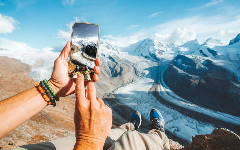 Personal perspective of person photographing Gorner Glacier with smartphone