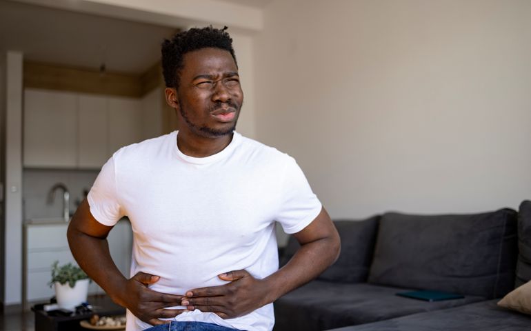 Young African American man feeling sick at home